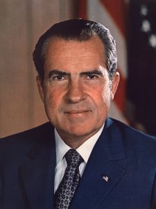Nixon and Johnson looking across a table at each other