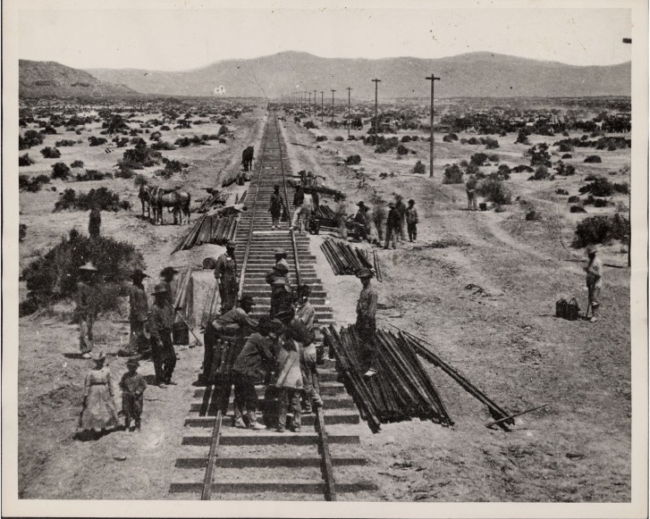 People building railroad tracks